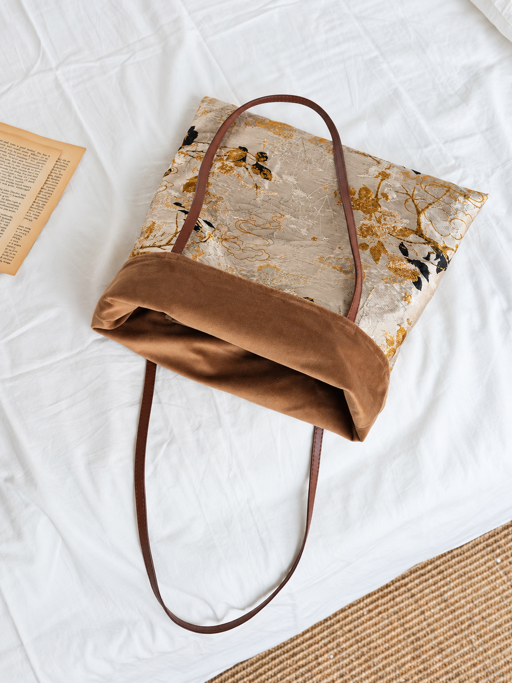 Golden Reverie floral tote folded open to show the brown interior and shoulder handles.