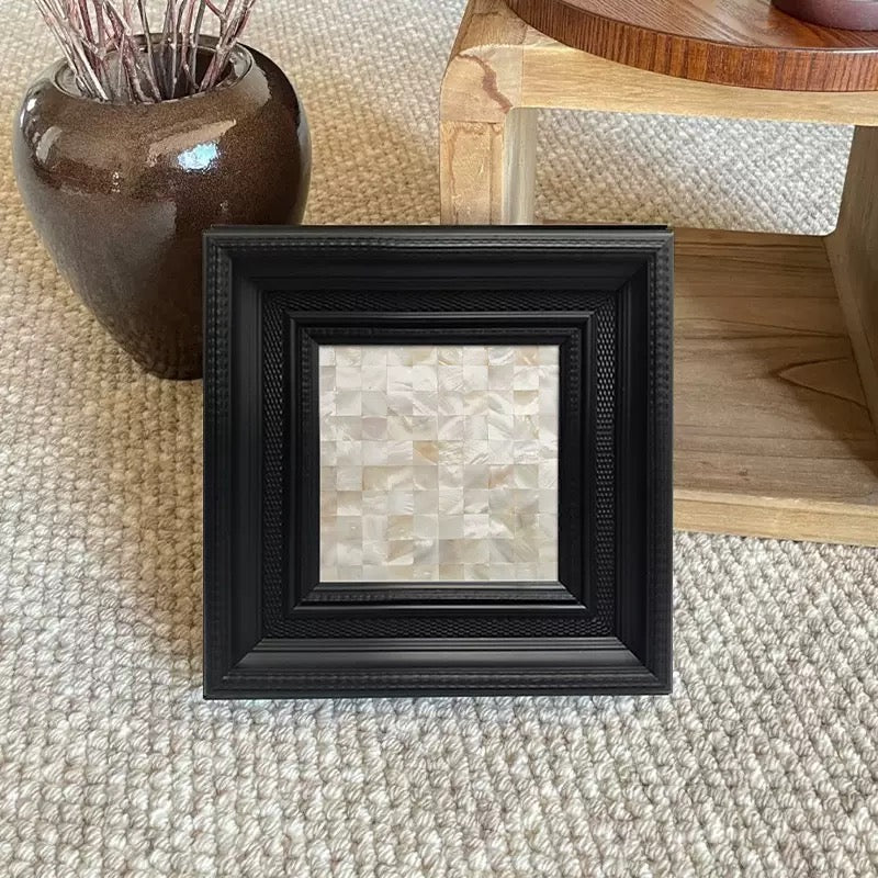 A luxury statement piece for curated spaces. This square framed art features a unique mother-of-pearl geometric pattern borde