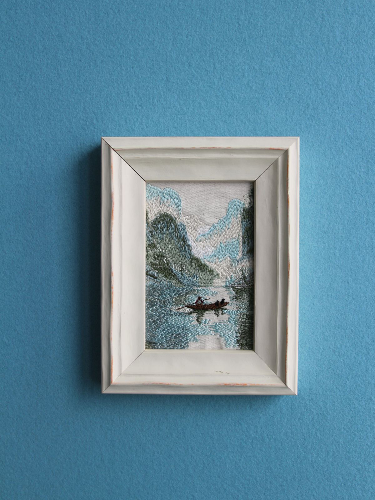 Front wall view of Guilin karst river embroidery in a white wood frame