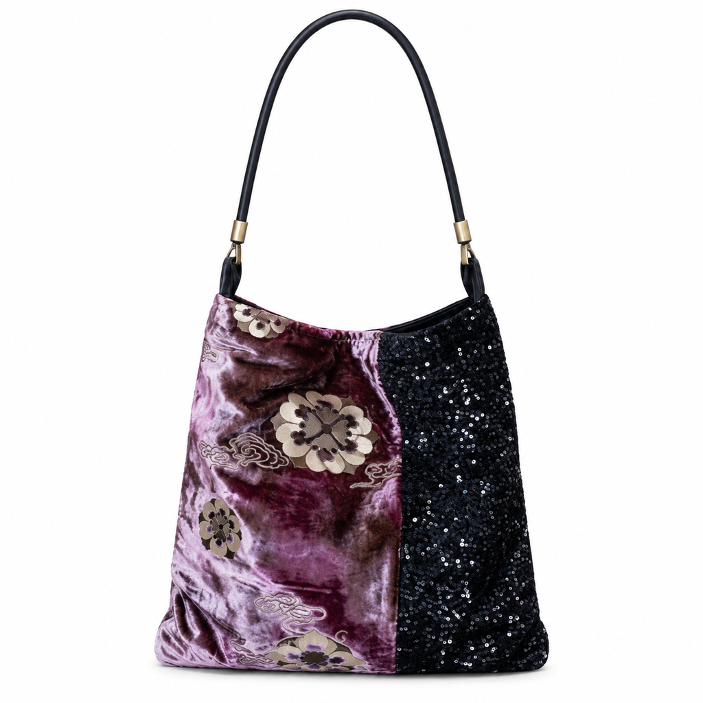 Purple floral velvet and black sequin shoulder bag with black leather strap, front view on white.