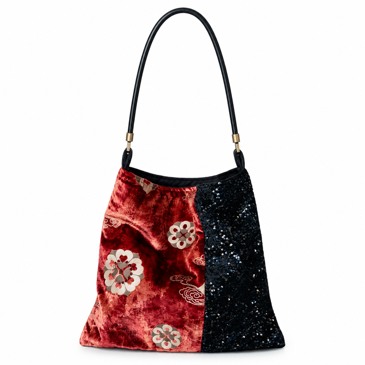 Red floral velvet and black sequin shoulder bag with black leather strap, front view on white.